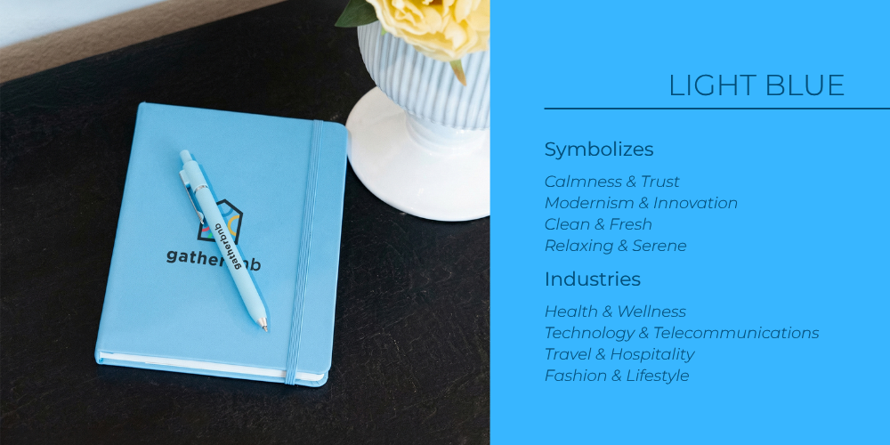 Light blue notebook and pen styled on a desk as branded swag, reflecting this shades calm, modern brand feel