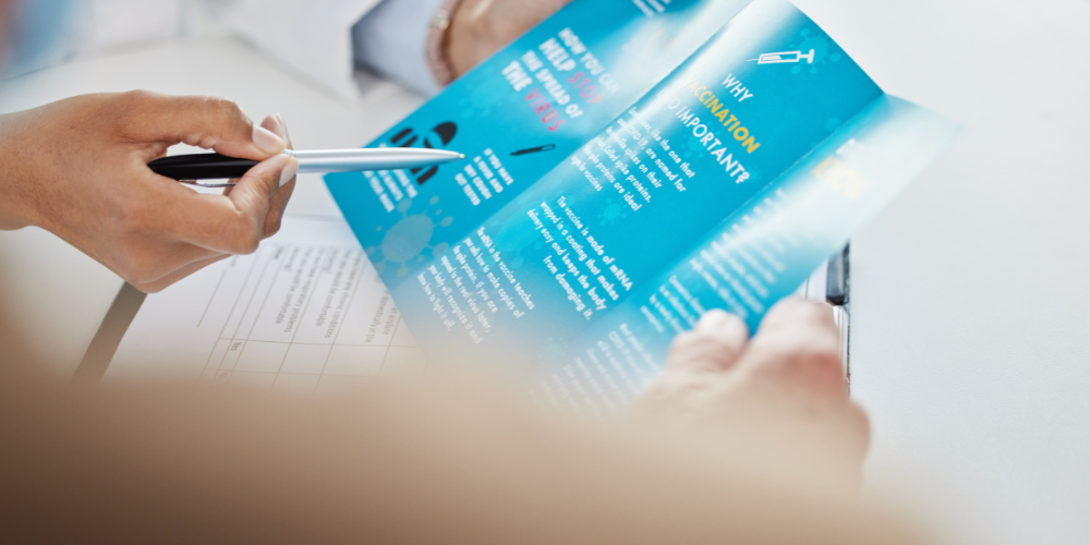 hand reviewing a printed medical brochure